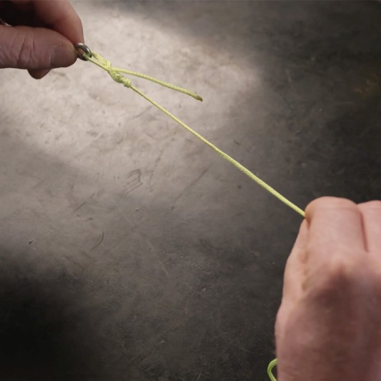 The standing line and the tag end are being pulled to tighten a knot.